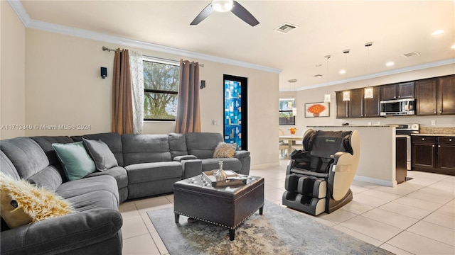 tiled living room with ceiling fan and crown molding