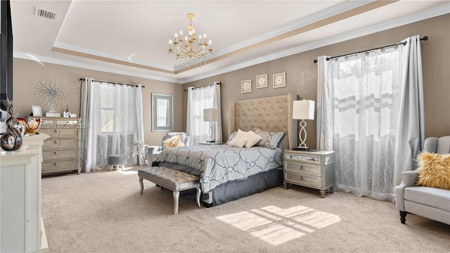 carpeted bedroom with ornamental molding, a tray ceiling, and a notable chandelier