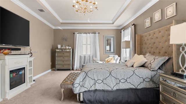 carpeted bedroom with a tray ceiling, crown molding, and a chandelier