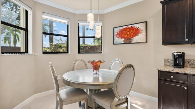 dining room with crown molding and light tile patterned floors