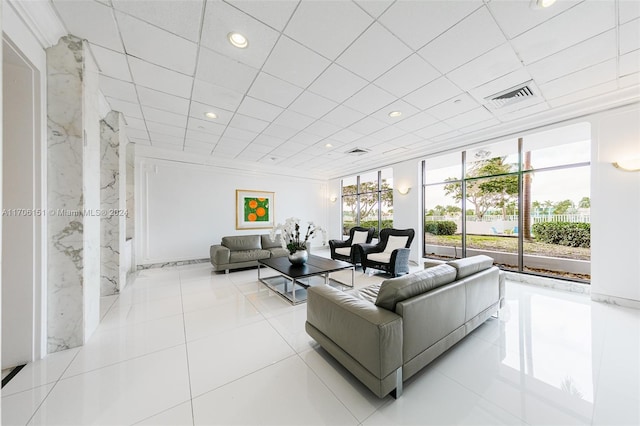 tiled living room with a wall of windows and a wealth of natural light