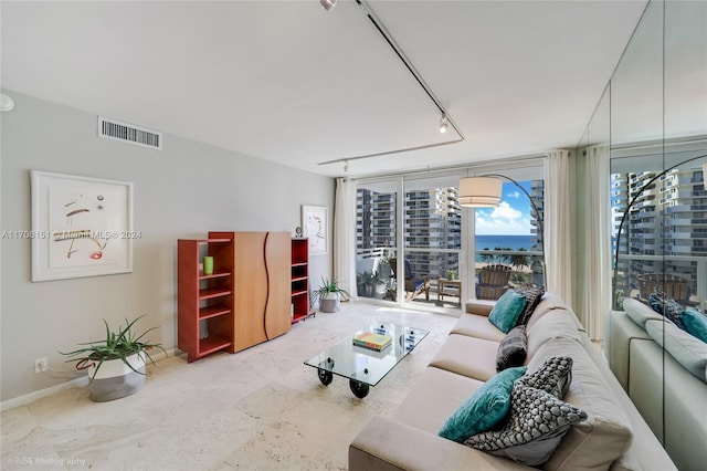 living room with track lighting and a wall of windows