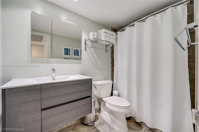 bathroom featuring tile patterned flooring, vanity, and toilet