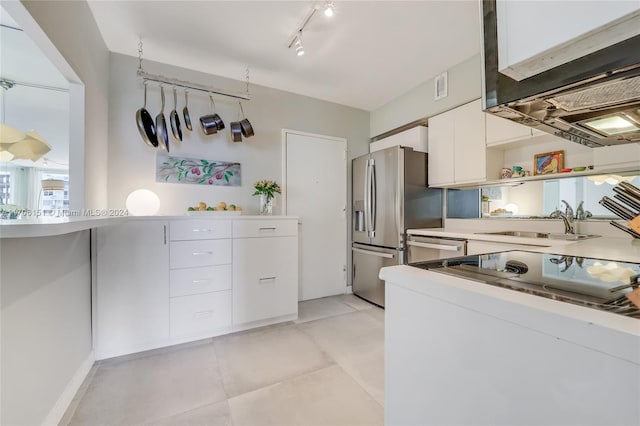 kitchen with dishwasher, sink, stainless steel fridge, white cabinets, and range