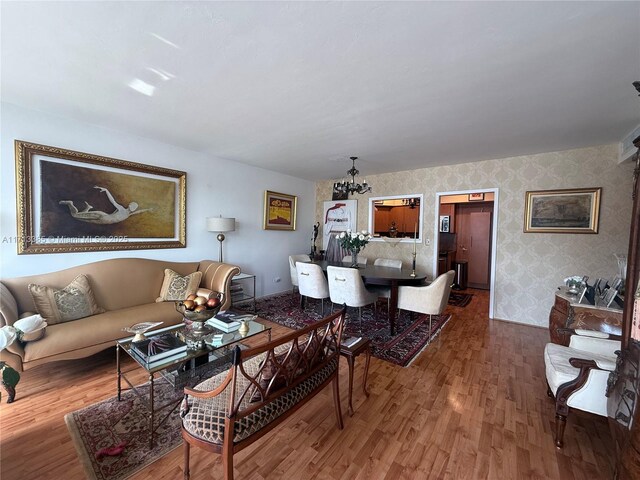 living room with hardwood / wood-style flooring and a chandelier