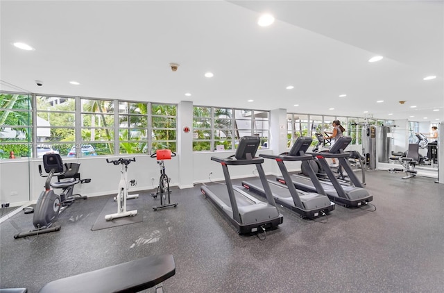 gym with baseboards and recessed lighting