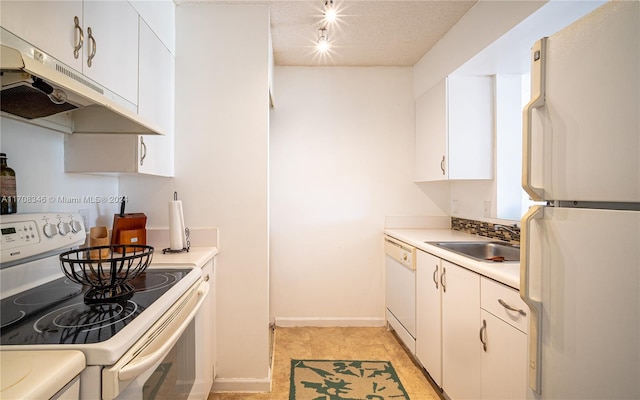 kitchen with sink, white cabinets, track lighting, white appliances, and light tile patterned flooring