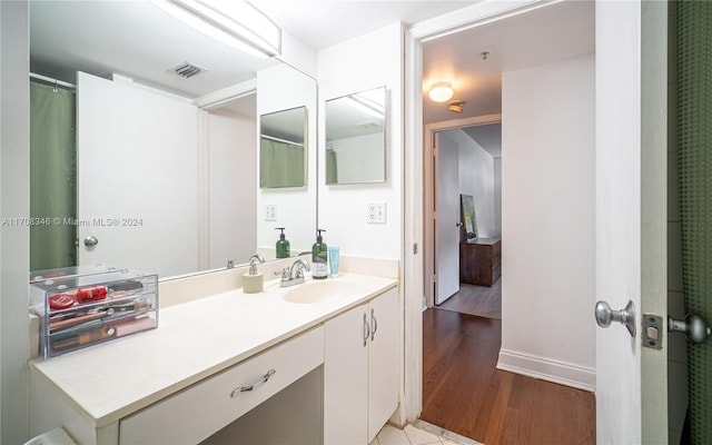 bathroom featuring hardwood / wood-style floors and vanity