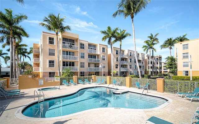 view of pool with a patio area and a hot tub