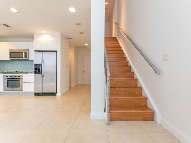 stairs featuring tile patterned floors