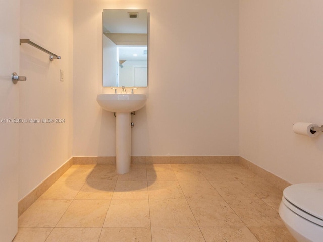 bathroom with tile patterned flooring and toilet