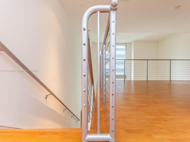 stairs featuring hardwood / wood-style floors