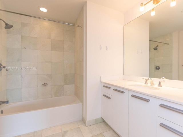 bathroom featuring tile patterned flooring, vanity, and tiled shower / bath combo