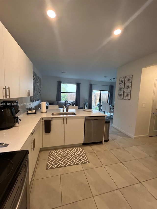 kitchen with sink, white cabinets, stainless steel dishwasher, kitchen peninsula, and light tile patterned flooring