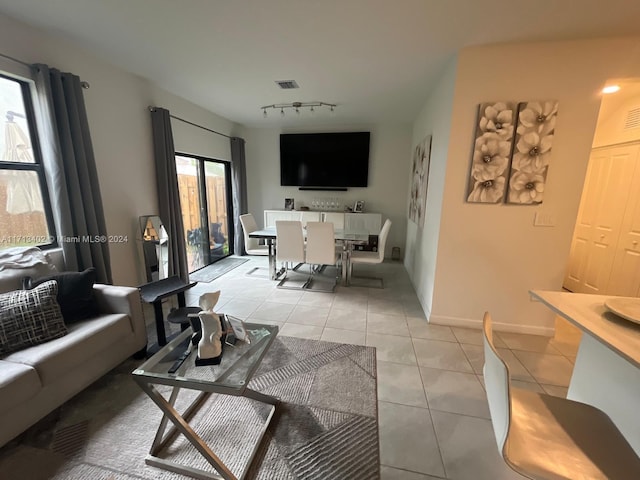 living room featuring light tile patterned floors and track lighting