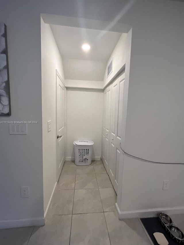 corridor with light tile patterned floors