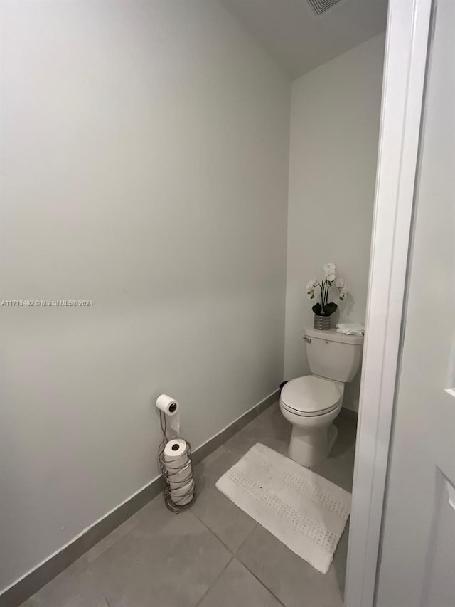 bathroom with tile patterned floors and toilet