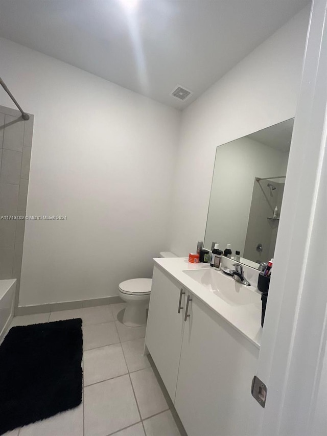 bathroom with tile patterned flooring, vanity, and toilet