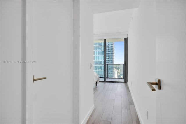 corridor with light hardwood / wood-style floors