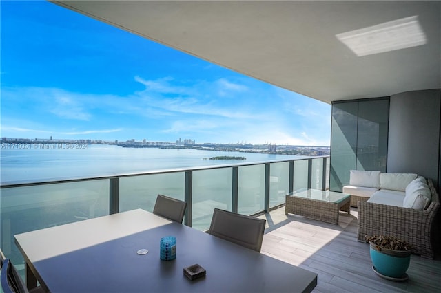 balcony with outdoor lounge area and a water view