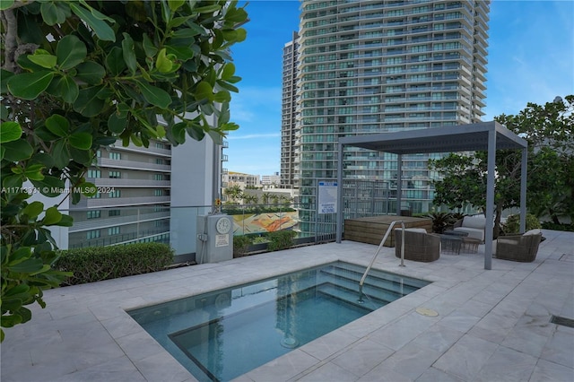 view of pool featuring a patio area and a hot tub