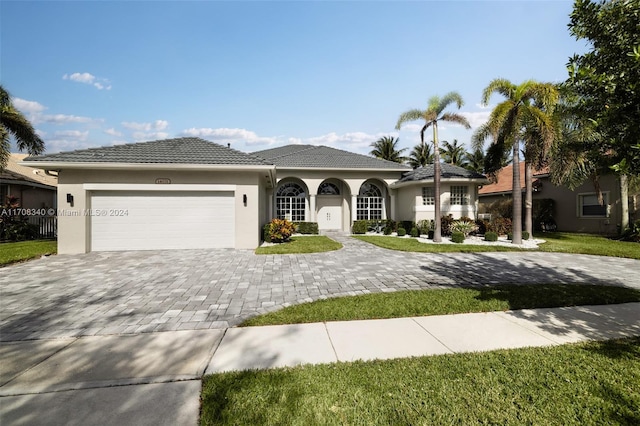 view of front facade with a front yard and a garage