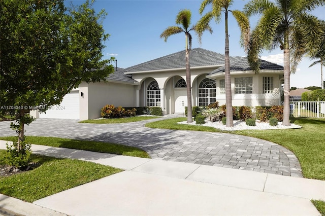 view of front of home with a front lawn and a garage