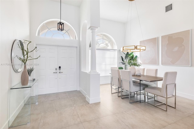 entryway featuring ornate columns and a towering ceiling