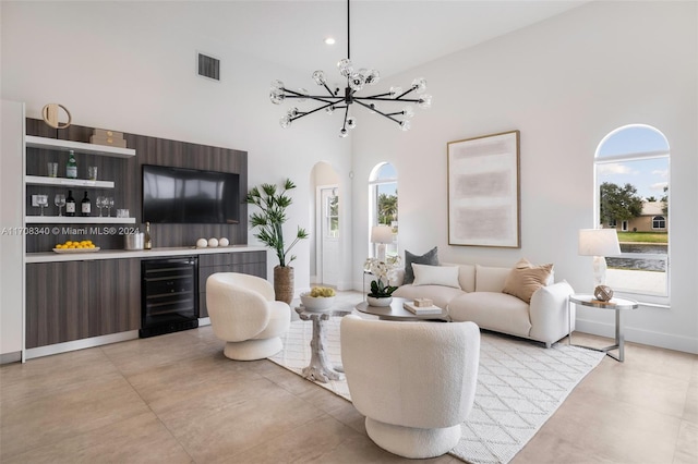 living room with wine cooler, a wealth of natural light, and a high ceiling