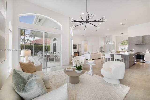 living room with a chandelier, a high ceiling, and sink