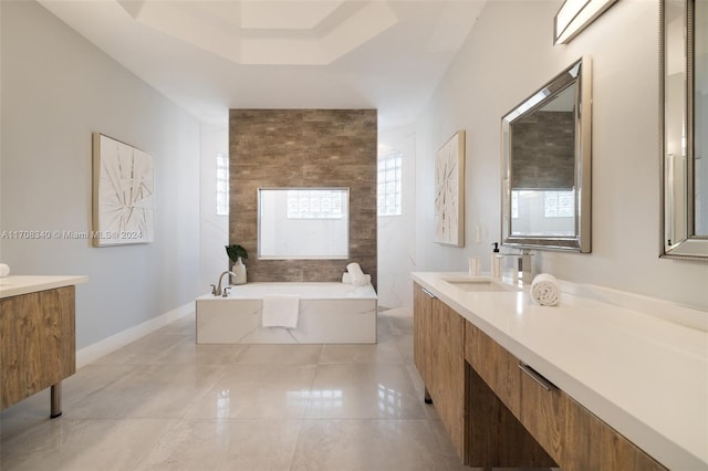 bathroom with a washtub and vanity