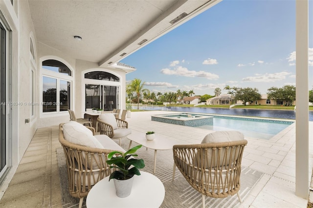 exterior space featuring a swimming pool with hot tub and a water view