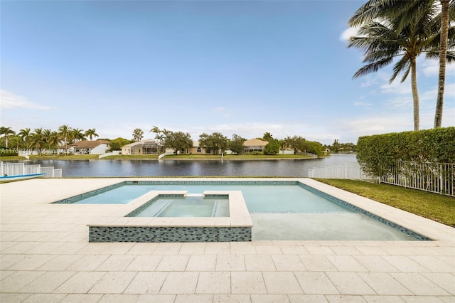 view of pool with an in ground hot tub and a water view