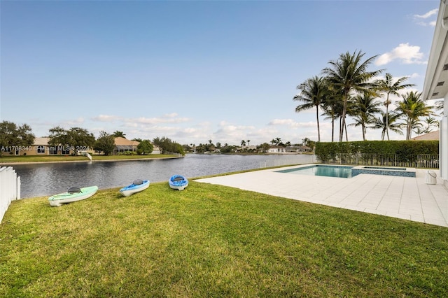 view of swimming pool with a water view, a yard, and a patio