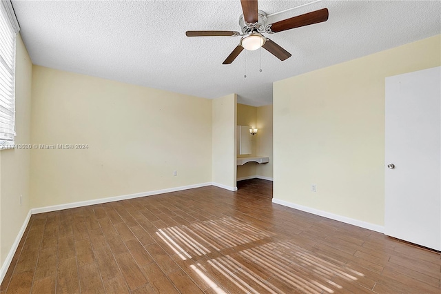 unfurnished room with a textured ceiling, hardwood / wood-style flooring, and ceiling fan