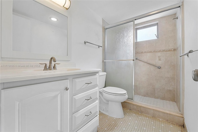 bathroom with tile patterned flooring, vanity, toilet, and an enclosed shower