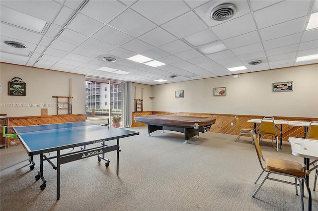 recreation room featuring carpet flooring, a drop ceiling, wood walls, and pool table