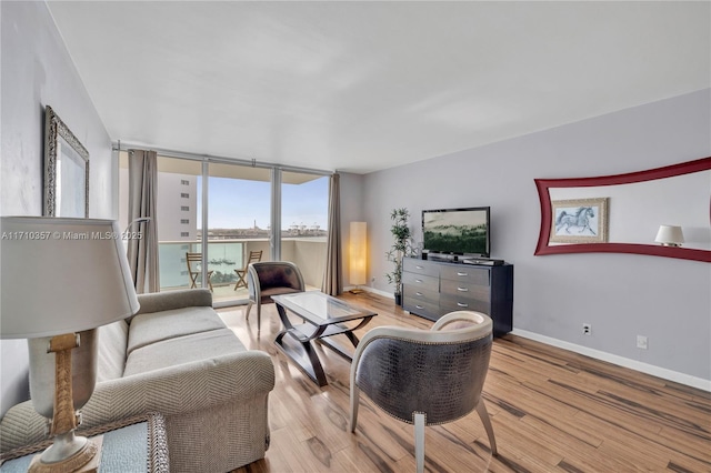 living room featuring light hardwood / wood-style floors and floor to ceiling windows