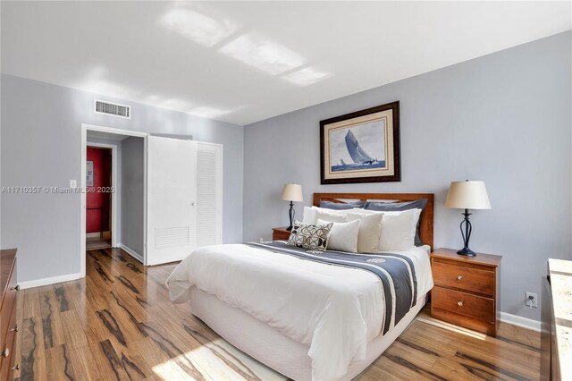 living room featuring light hardwood / wood-style flooring and a notable chandelier