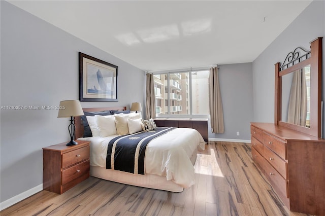 bedroom featuring light hardwood / wood-style floors and multiple windows