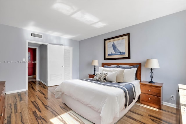 bedroom featuring hardwood / wood-style flooring and a closet