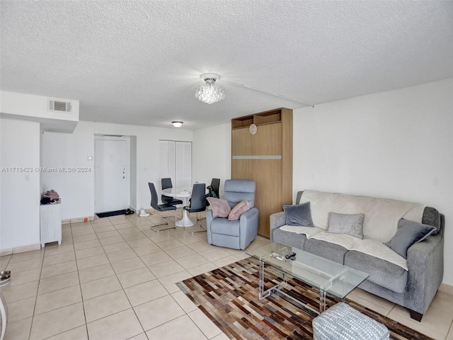 living room featuring light tile patterned flooring and a textured ceiling