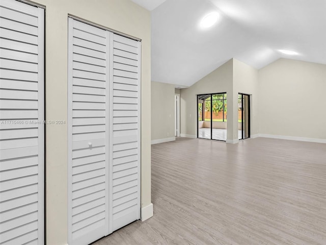 interior space with light hardwood / wood-style flooring and lofted ceiling