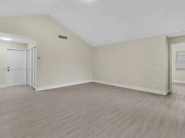 unfurnished living room with light hardwood / wood-style floors and vaulted ceiling