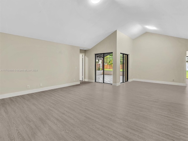 unfurnished living room featuring light hardwood / wood-style floors and lofted ceiling