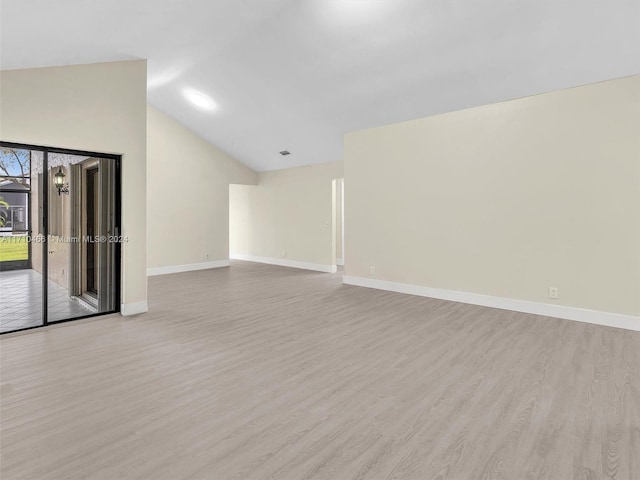 unfurnished living room with vaulted ceiling and light wood-type flooring