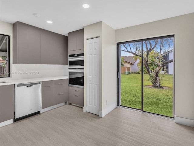 kitchen featuring gray cabinetry, stainless steel appliances, and light hardwood / wood-style flooring