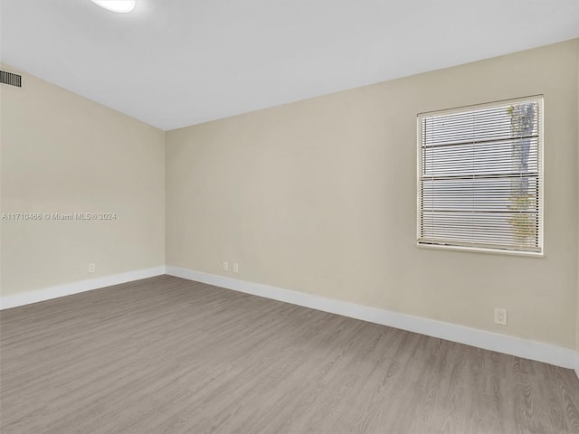 unfurnished room featuring hardwood / wood-style flooring