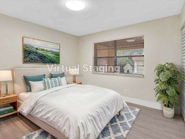 bedroom with hardwood / wood-style floors