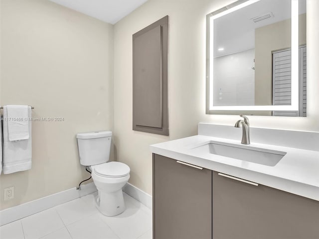 bathroom featuring tile patterned floors, vanity, and toilet